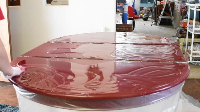 Red table coated in layer of red-tinted epoxy.