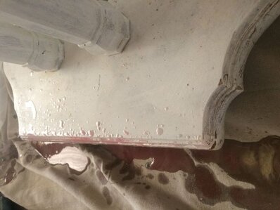 Resin that dripped down onto the floor and base of the table.